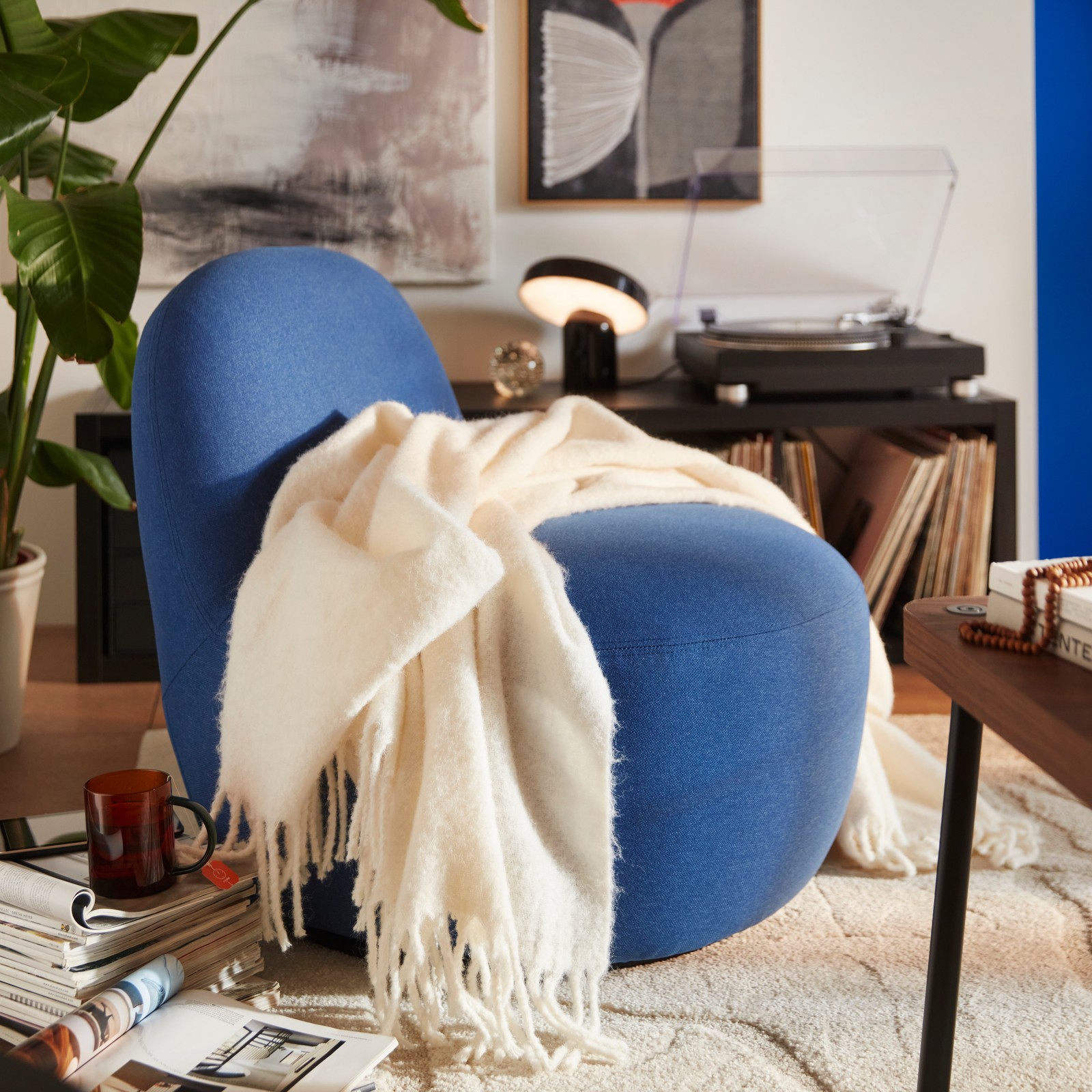 A Gunnared dark blue LILLESÄTER swivel easy chair in the living room