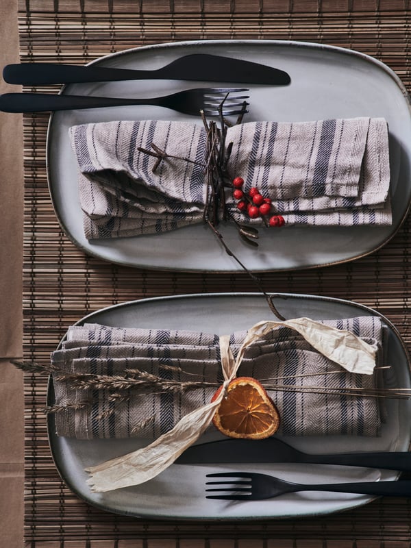 GLADELIG plates are styled with fabric napkins and natural decor like wild grass, dried orange slices and berries.