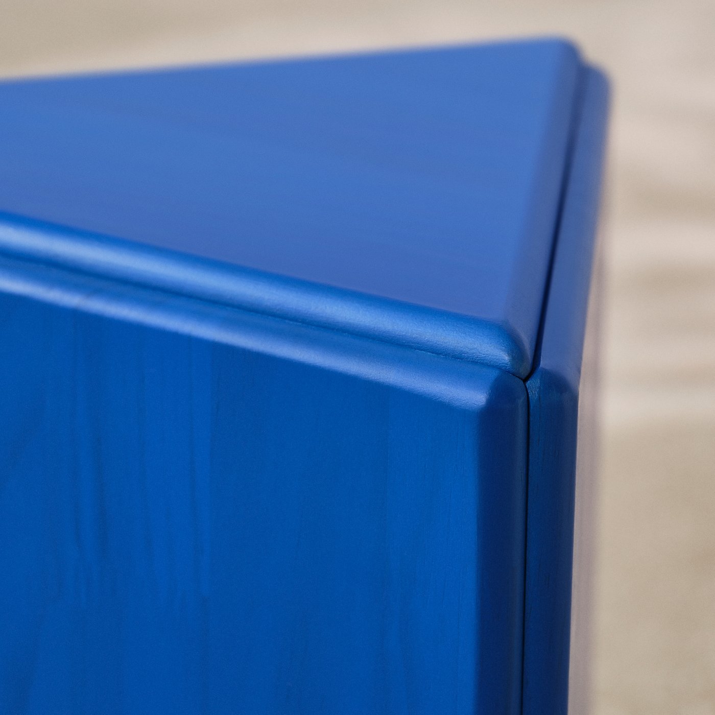 Close up of a blue wooden stool made by Andu Masebo as a part of IKEA KONSTRUNDA art collection.