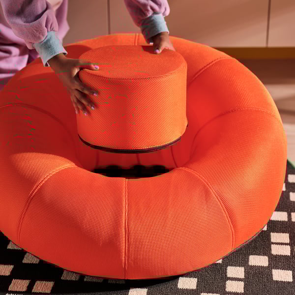 A black BRÄNNBOLL gaming rug in the living room