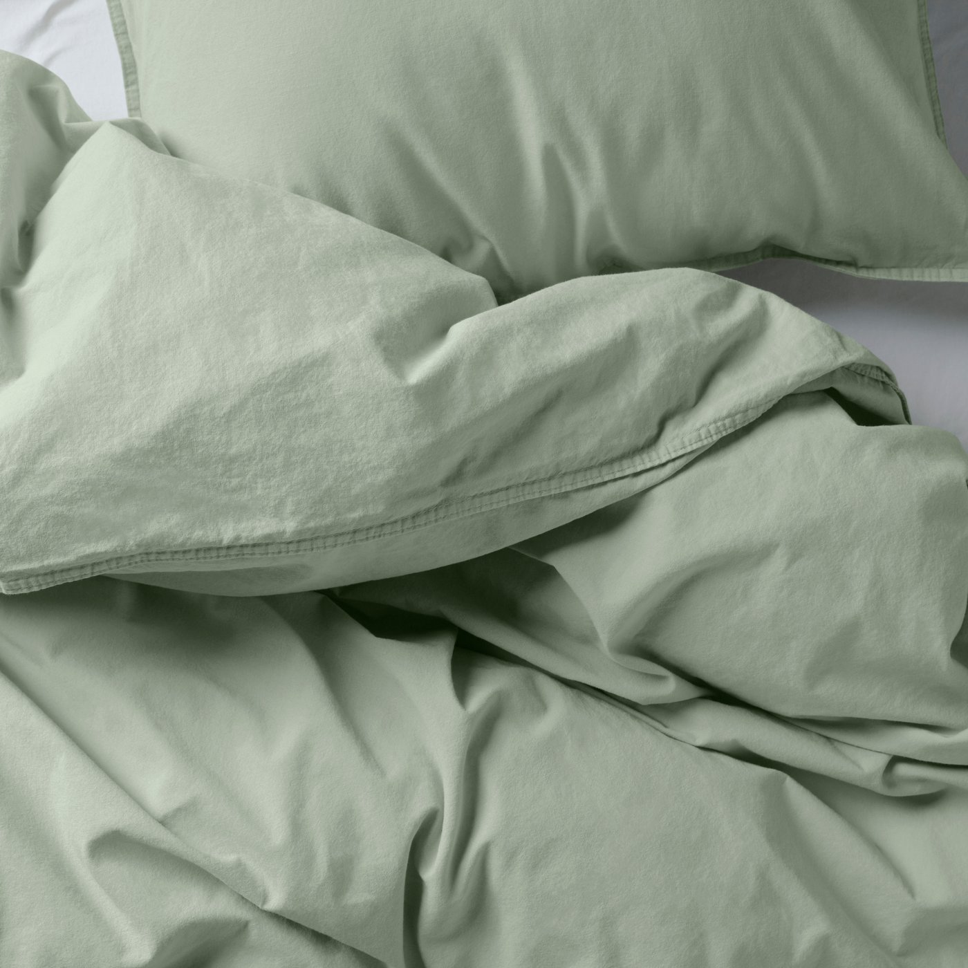 ÄNGSLILJA duvet cover set in pale grey-green with a soft surface.