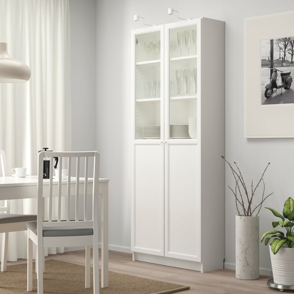 A white BILLY bookcase with panel/glass doors