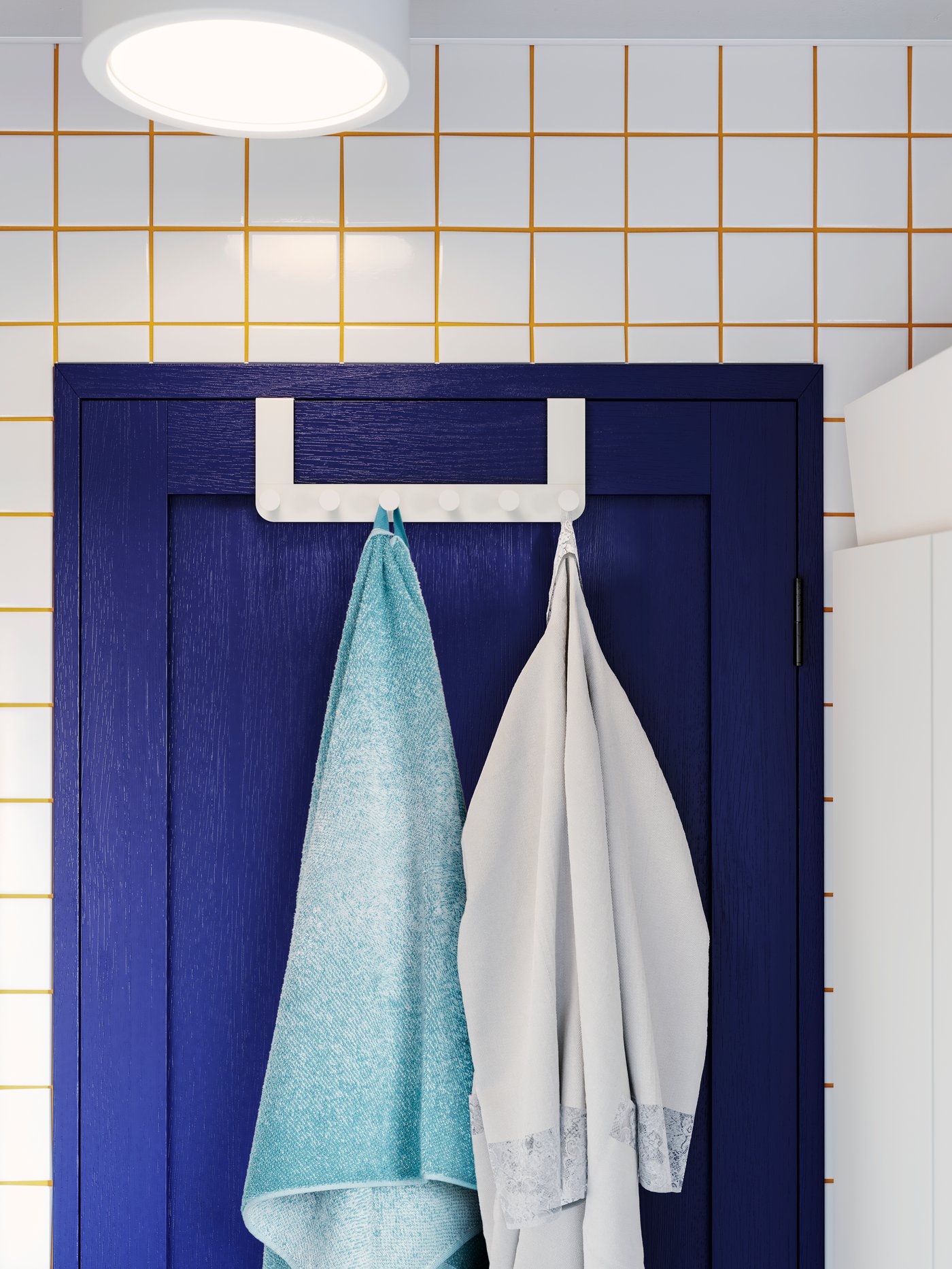 Blauwe deur met 2 handdoeken aan een ENUDDEN deurhanger