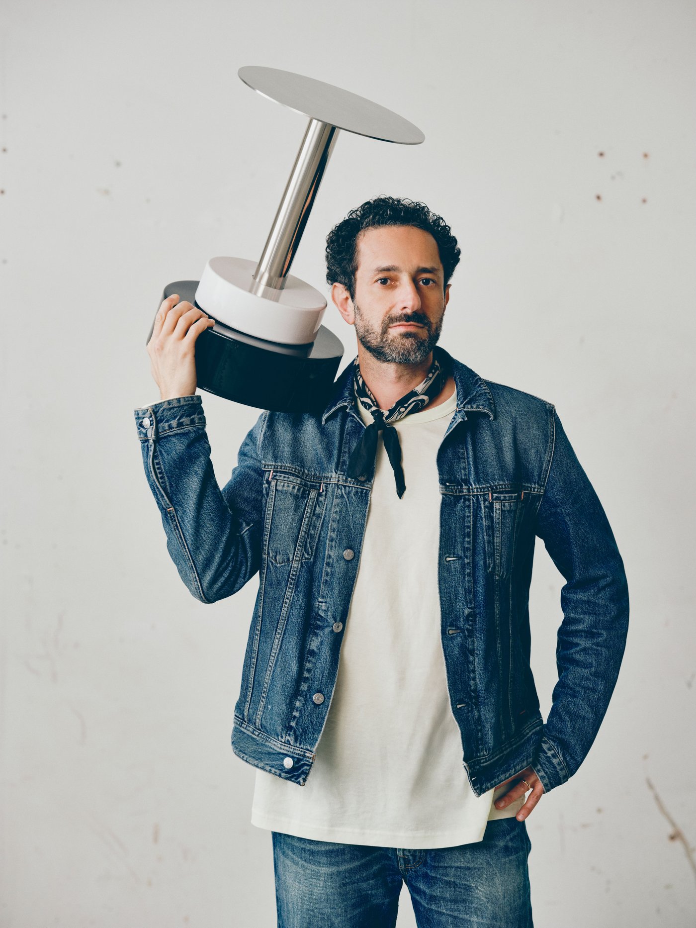 Close up of Emanuele Stamuli holding a black and white object designed for IKEA KONSTRUNDA art collection.