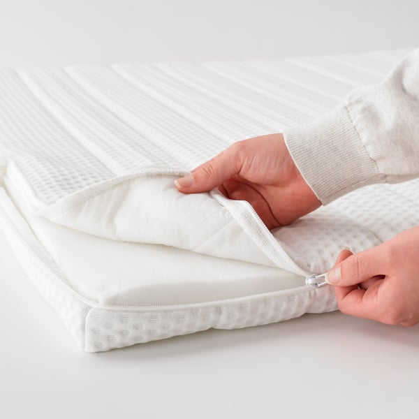A white NISSEHOLM mattress pad