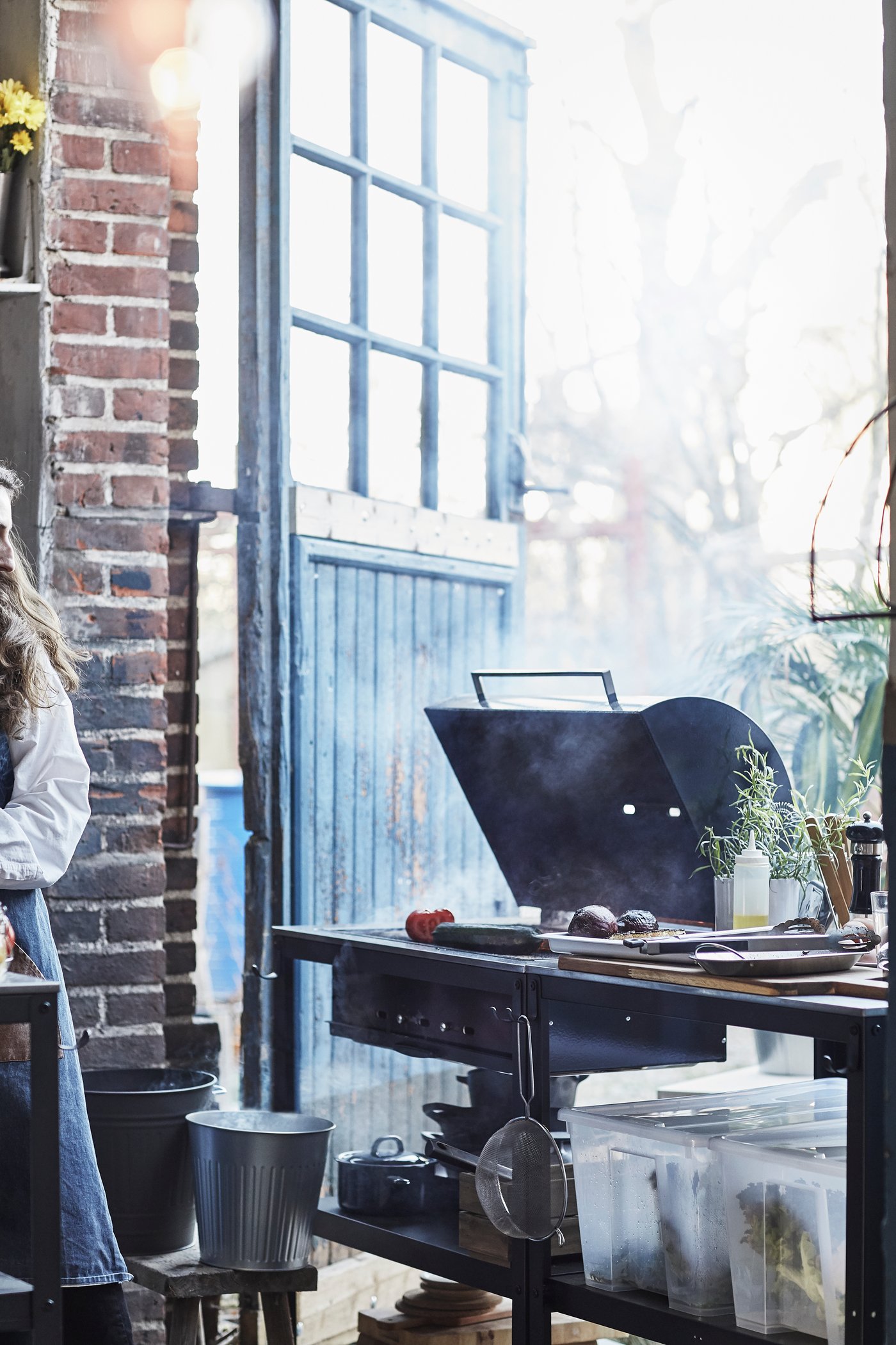 A black/stainless steel outdoor GRILLSKÄR charcoal barbecue