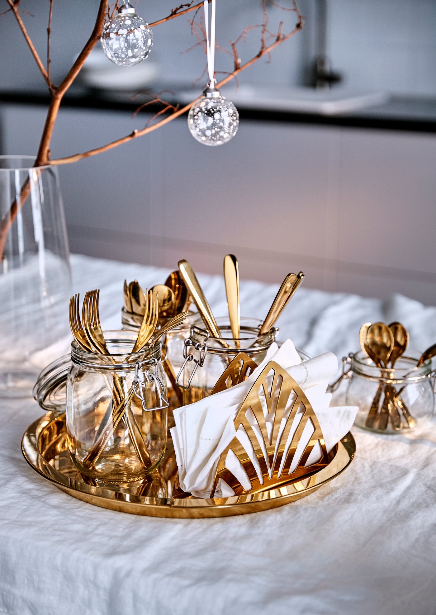 A brass-colour TILLAGD 24-piece cutlery set in the dining room