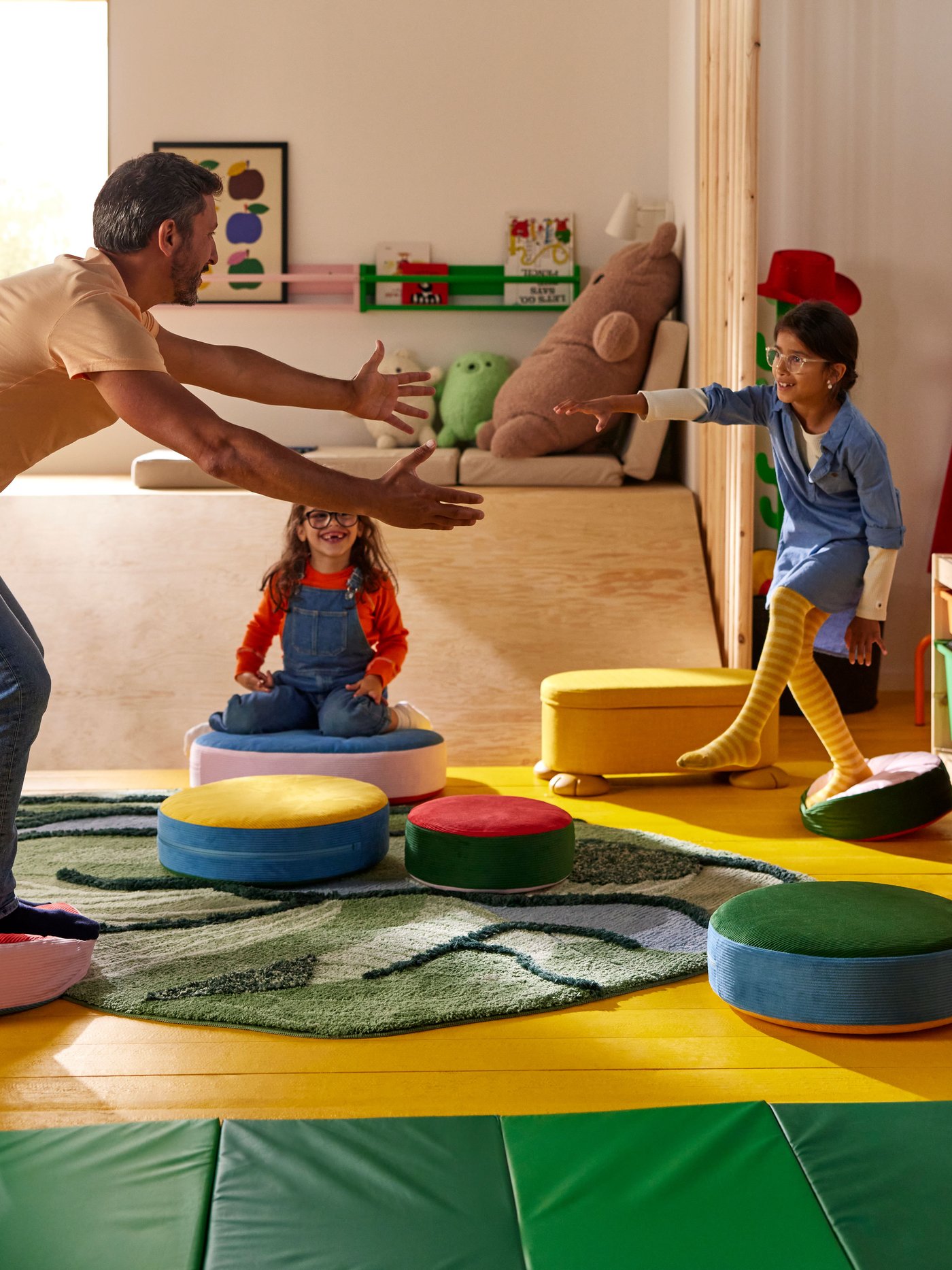 A green PLUFSIG folding gym mat in the childrens room