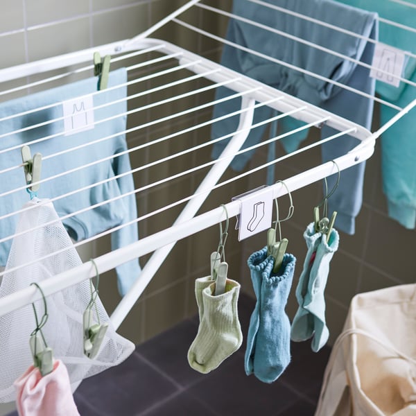 A green SLIBB hanging clothes peg
