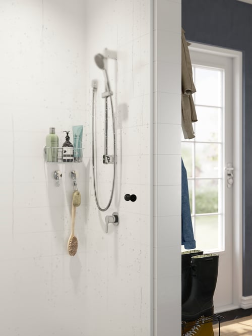 Bathroom corner featuring a BROGRUND riser rail with handshower wall outlet placed above a BROGRUND shower mixer.