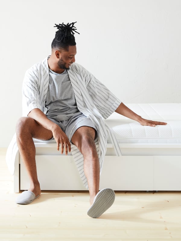 A firm/white ÅKREHAMN foam mattress in the bedroom