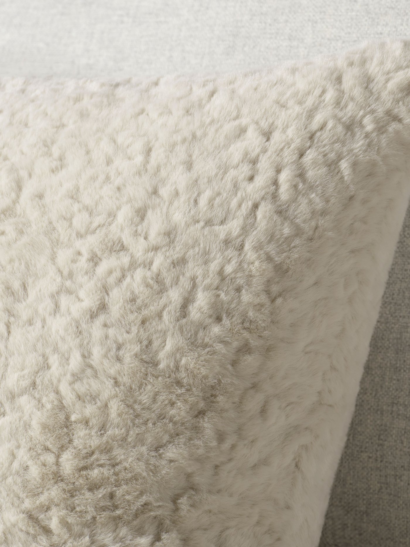 A beige NÄTNÄVA cushion cover