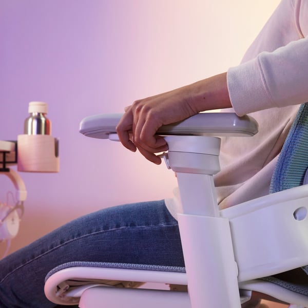 A close up of the arm of a white BÄSTBOLL gaming chair