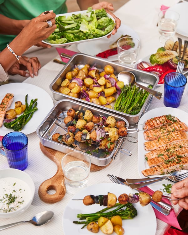 Meatball skewers with potatoes are served on a midsummer table.