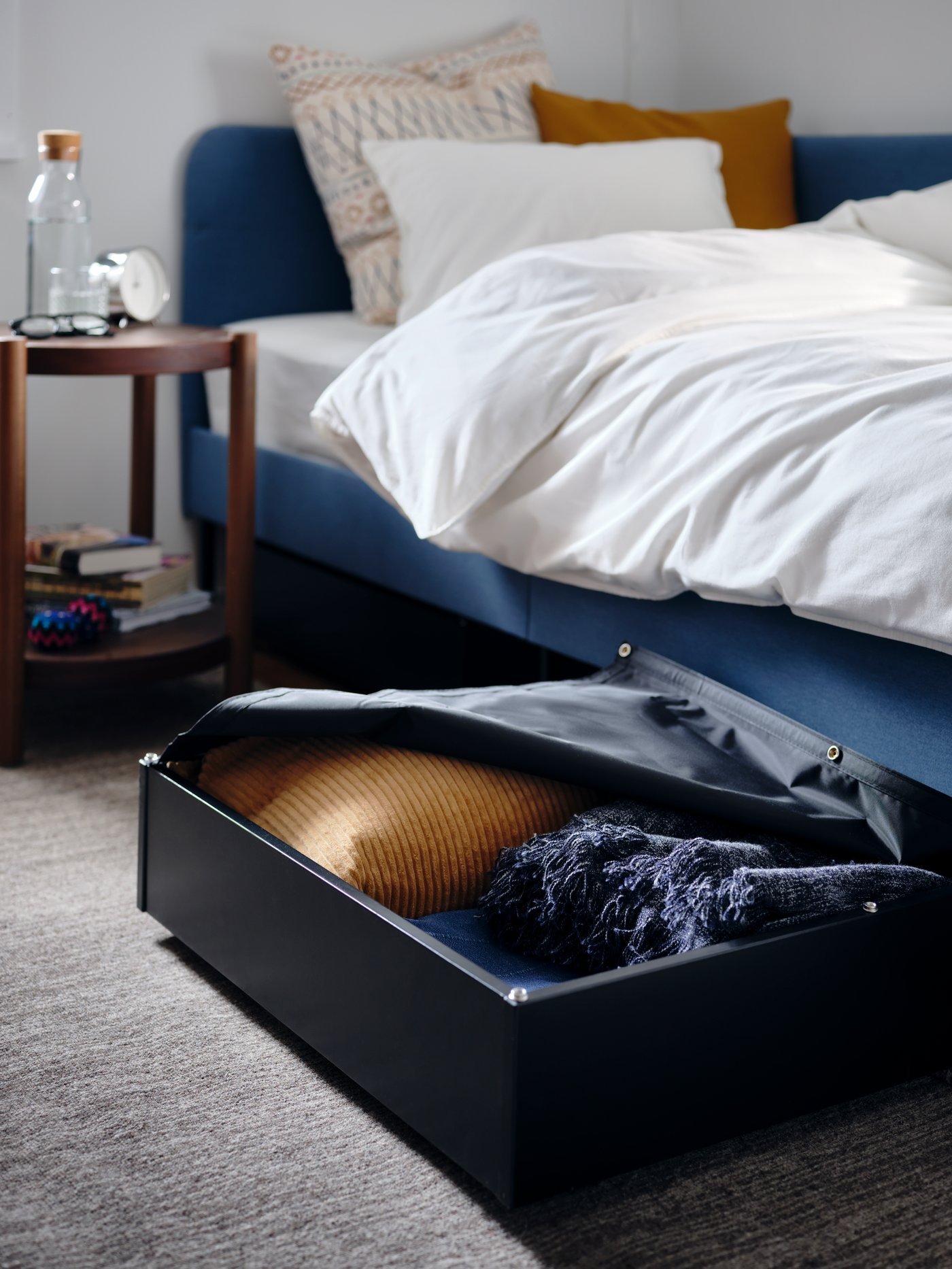 A dark beige ÅSVEIG cushion cover in the bedroom