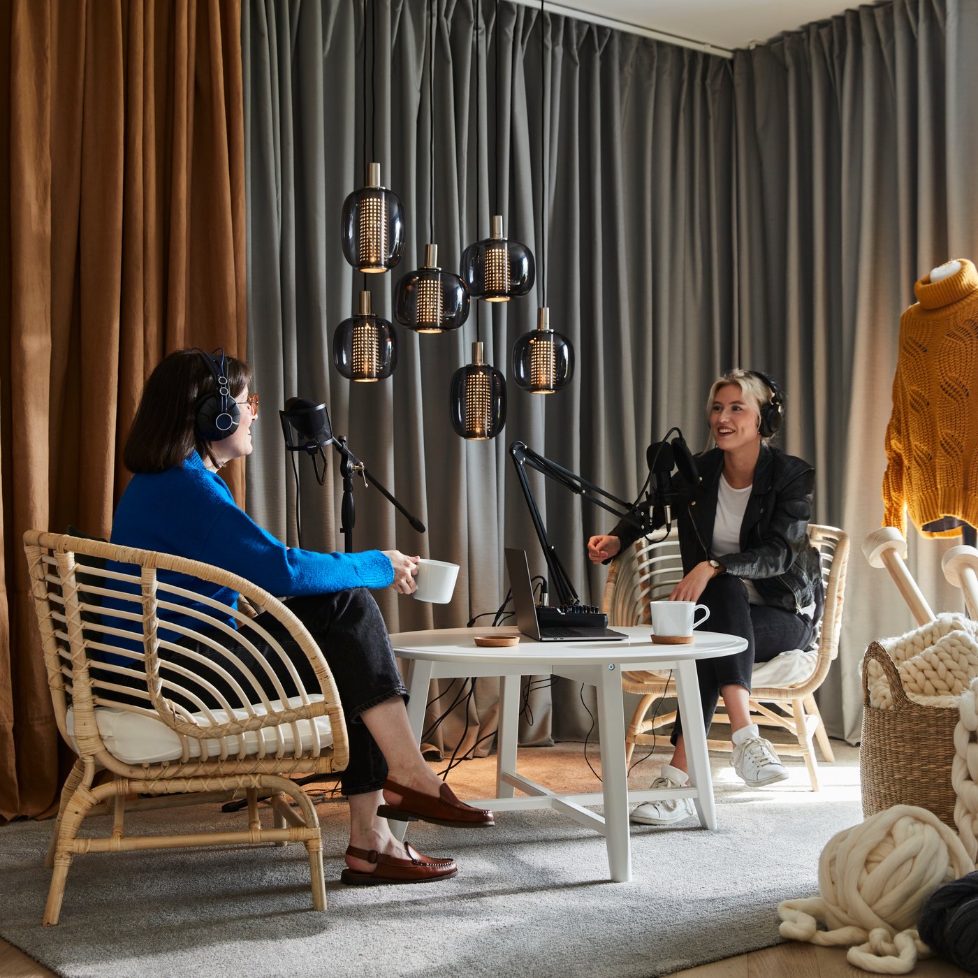 A pair of grey/white MAJGULL blackout curtains with pleating tape.