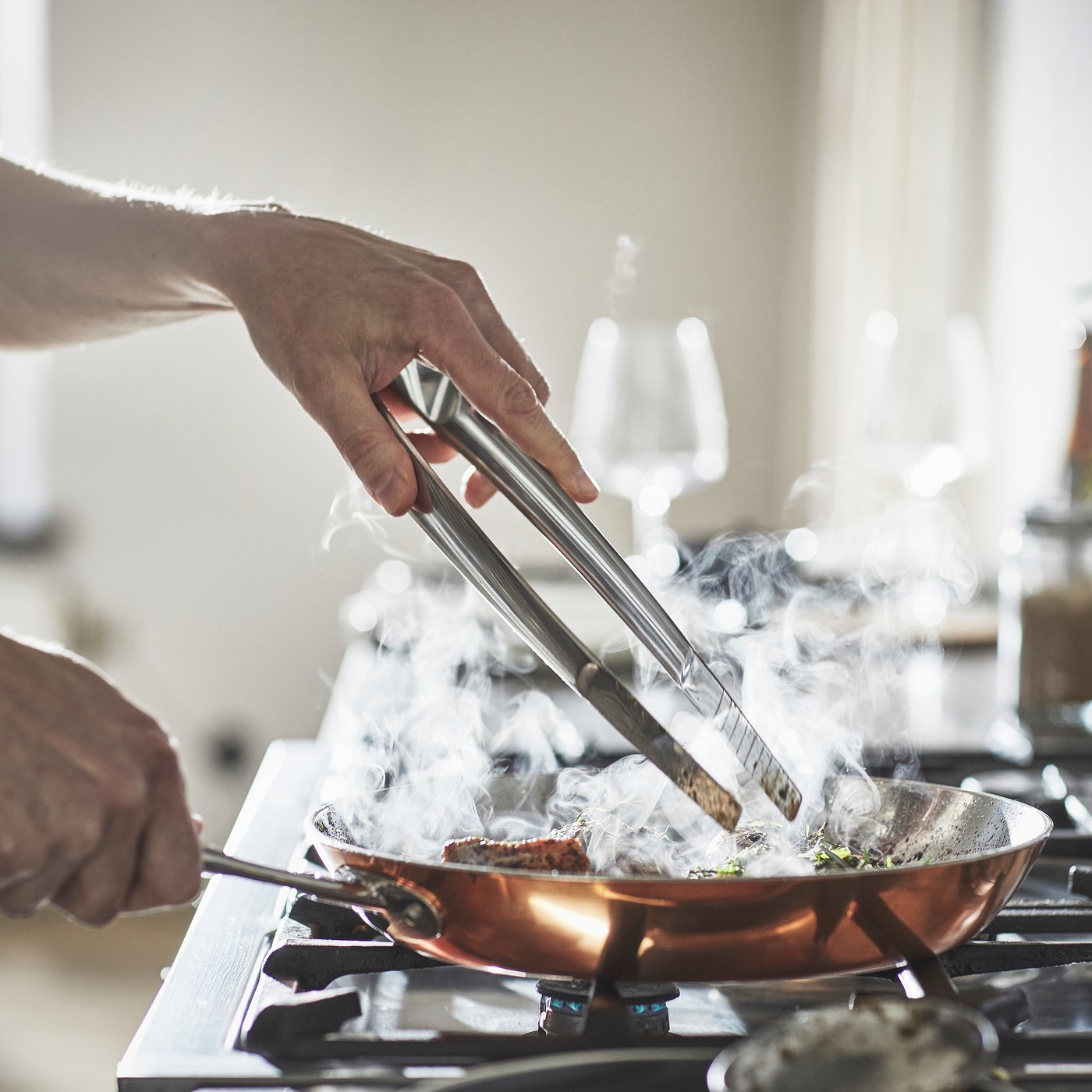 A stainless steel FINMAT cooking tweezers