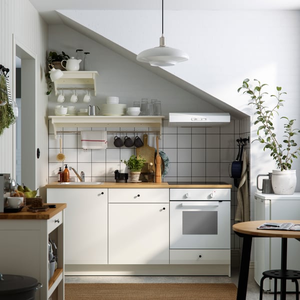 A white KNOXHULT base cabinet with doors and drawer in the kitchen