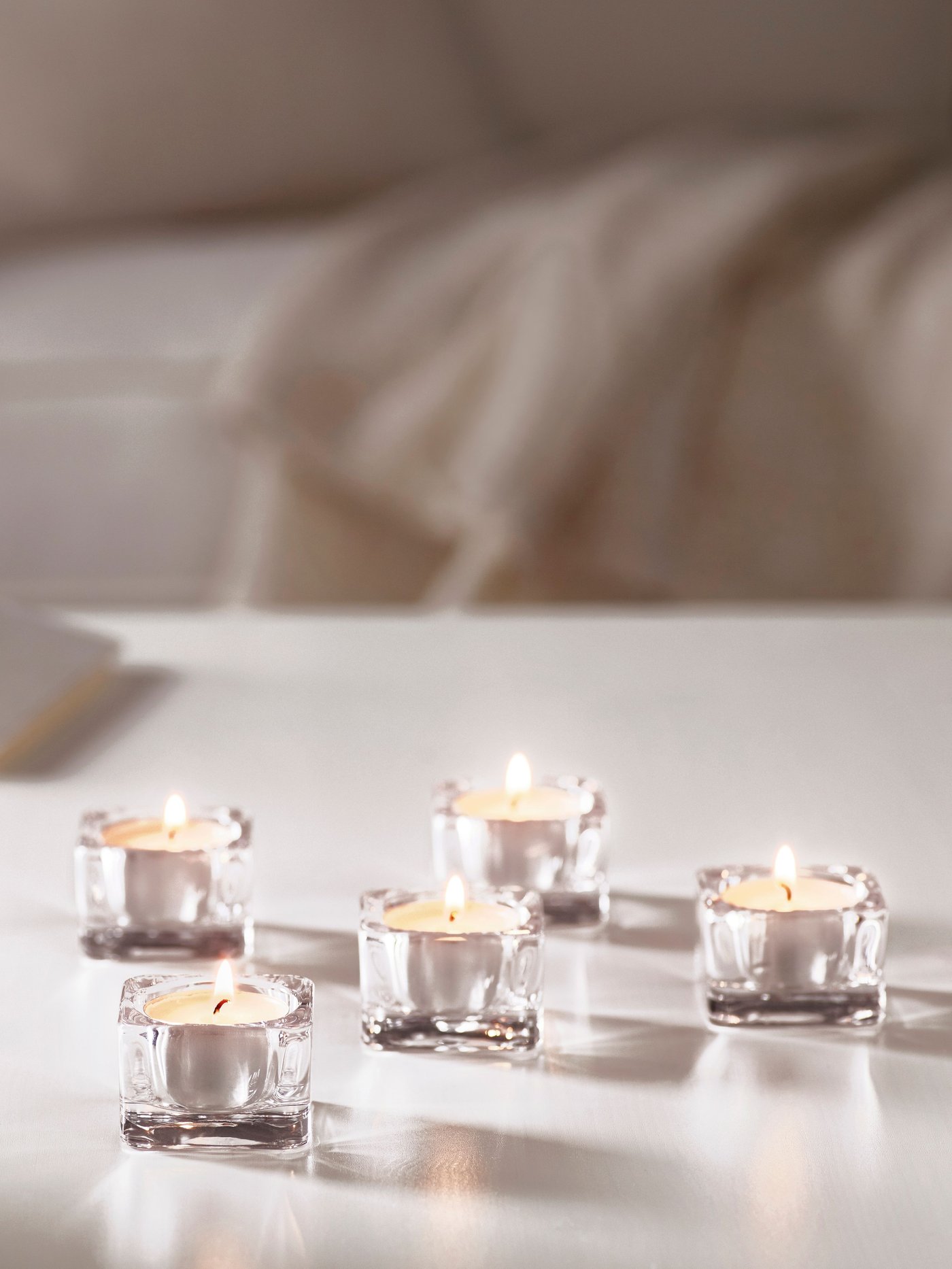 A GLIMMA unscented candle in metal cup