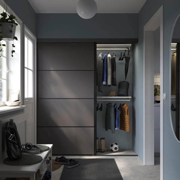 A black double sided/Mehamn dark grey BOAXEL reach-in wardrobe with sliding door in the bedroom