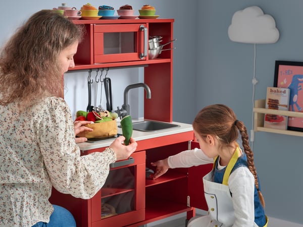 A red DUKTIG play kitchen 
