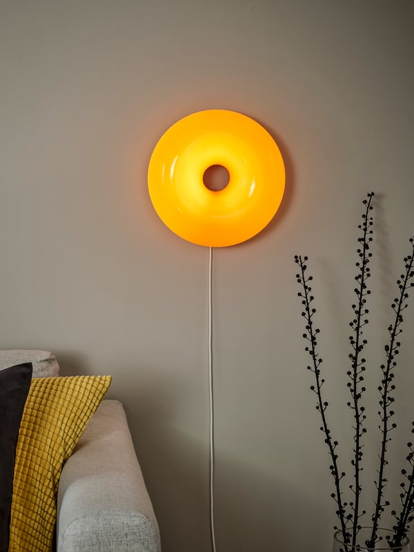 An orange glass/round VARMBLIXT LED table/wall lamp