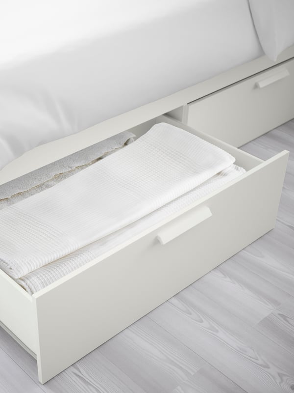 A white BRIMNES bed frame with storage