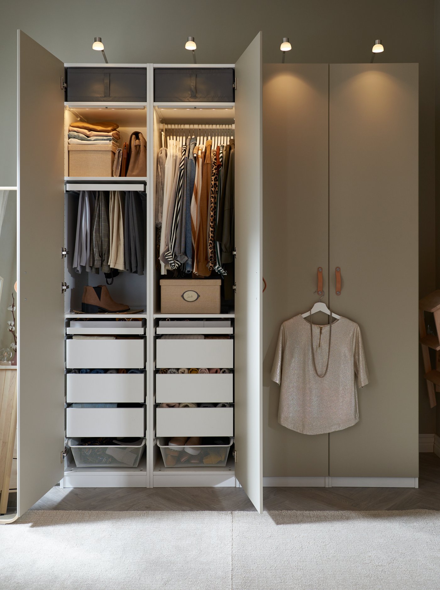 PAX wardrobe with hinged doors in a bedroom with integrated lighting.