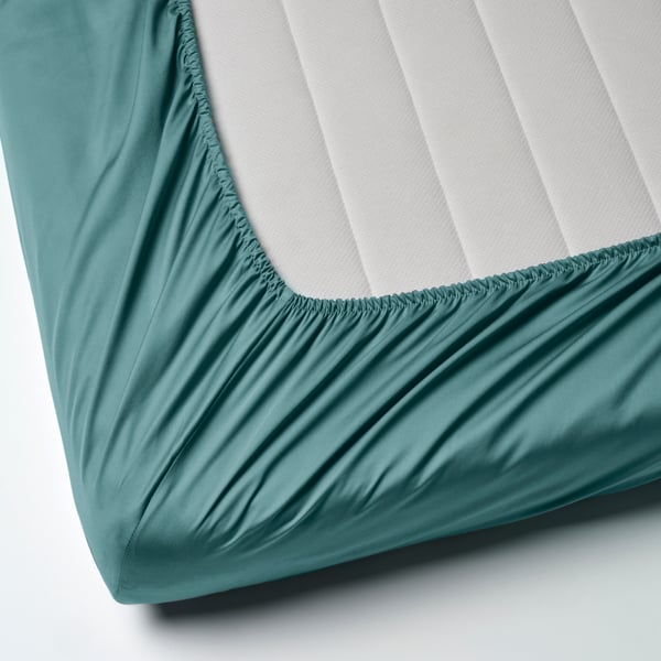 A blue-green NATTJASMIN fitted sheet