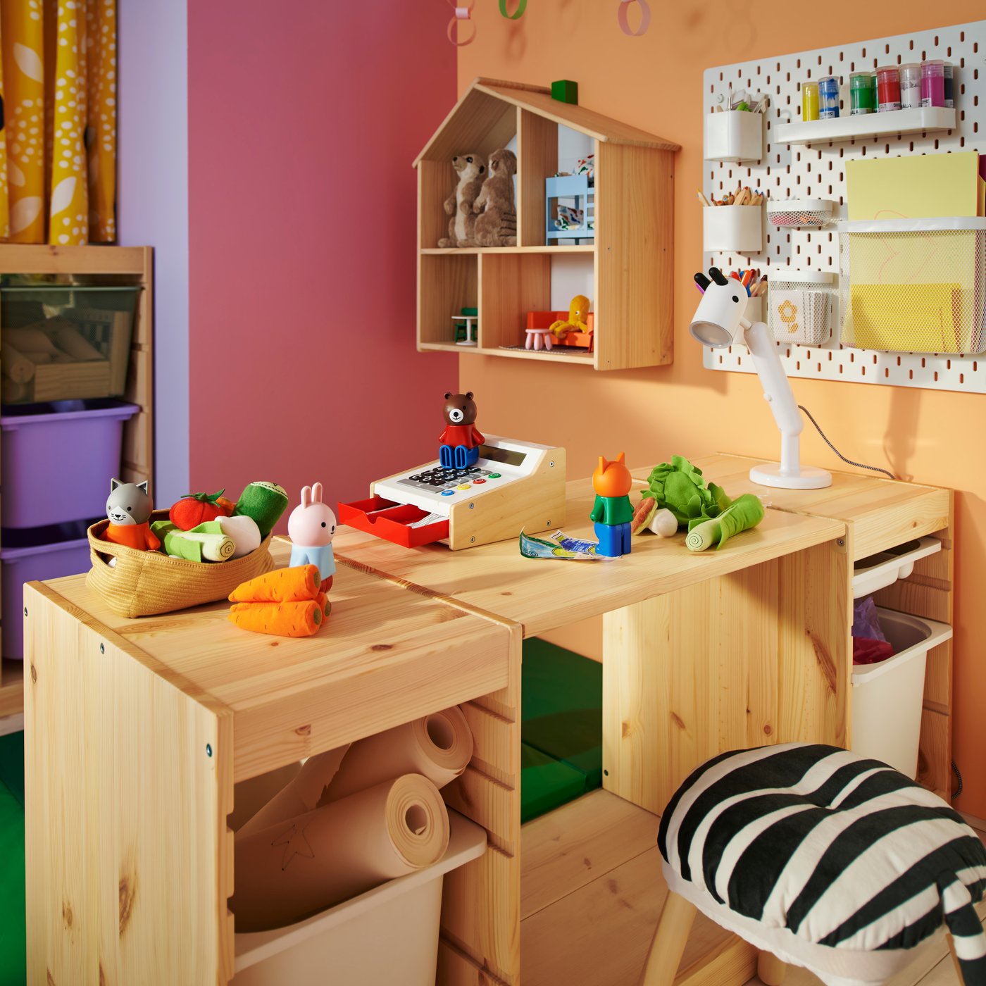 A light white stained pine TROFAST tabletop and two frames combined to create a desk in a colourful children’s bedroom.