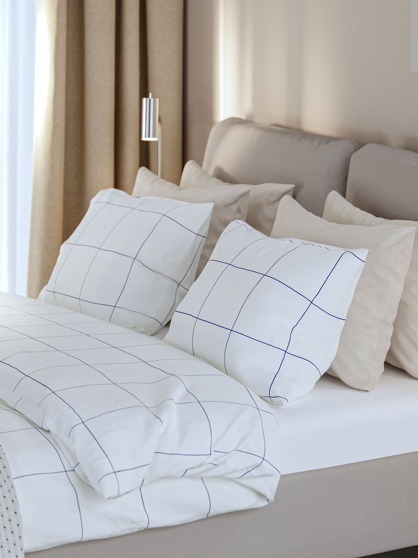 Ett hotellrum med en SAGESUND klädd säng bäddad med BREDVECKLARE sängkläder bredvid ett nattduksbord i ekfaner.