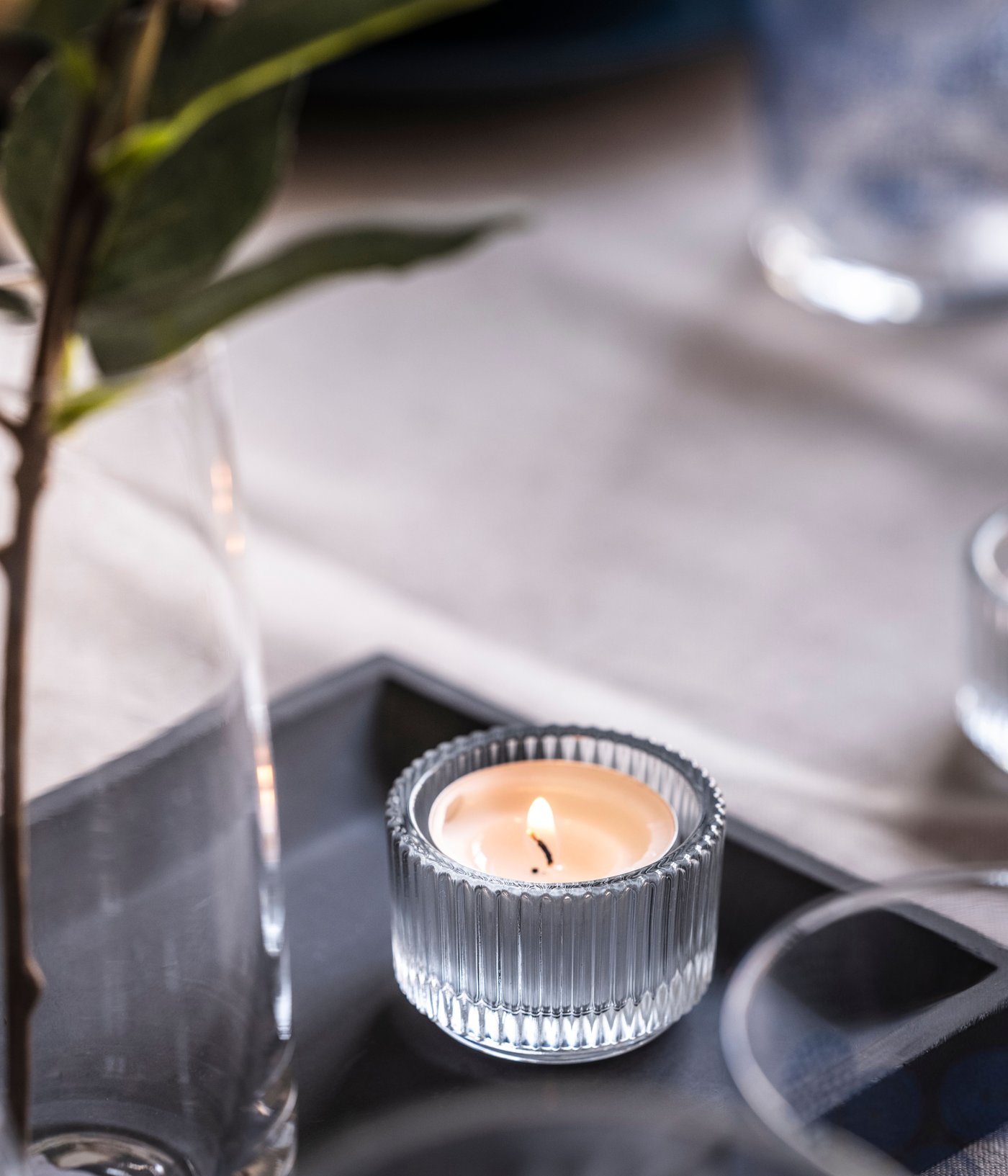 A GLIMMA unscented candle in metal cup