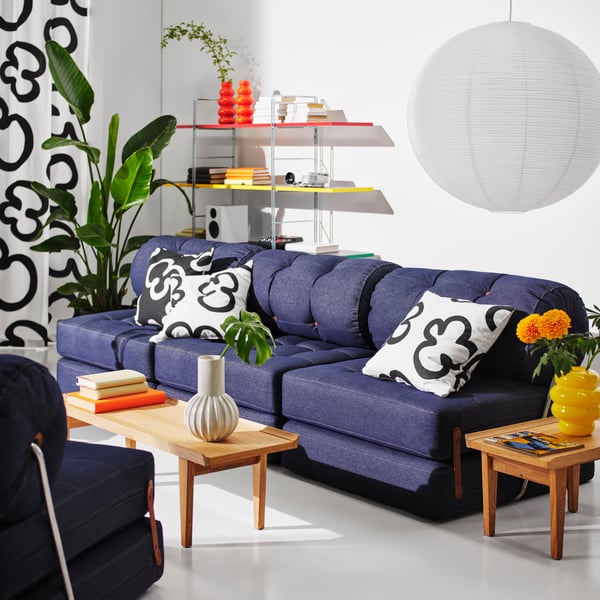 A Vansta blue VÅRKUMLA chair-bed in the living room