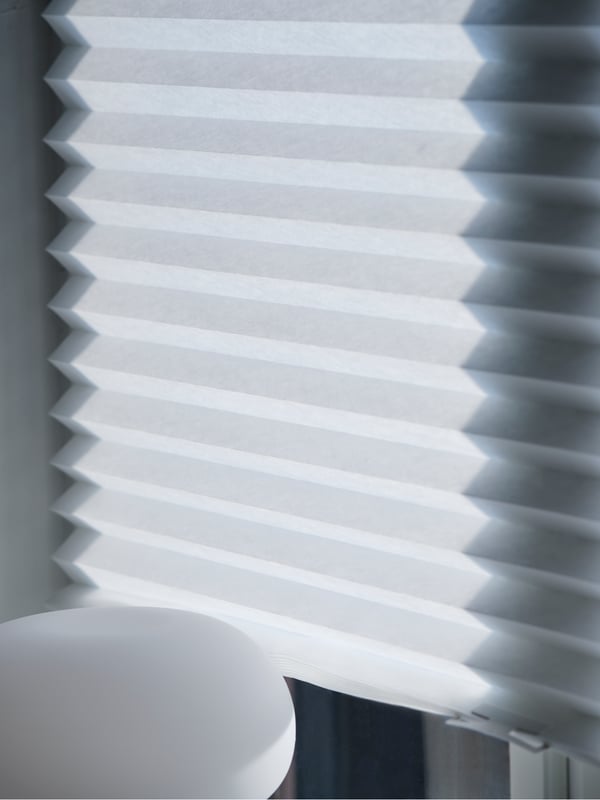 A white SCHOTTIS pleated blind in the bedroom