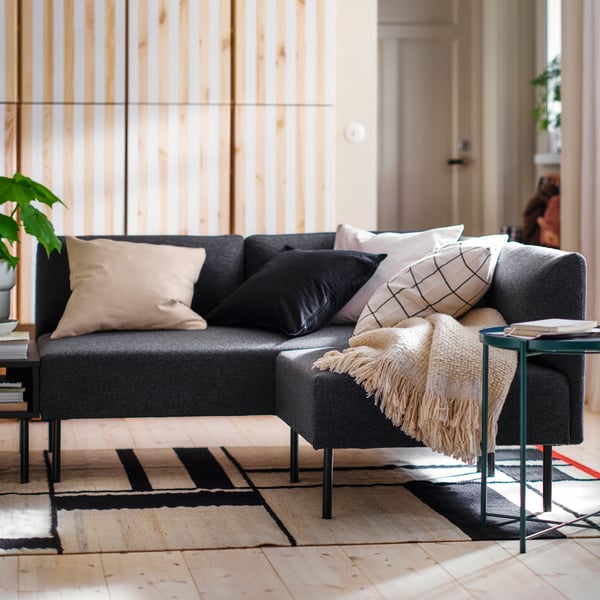 Cushions, including one with an unbleached GURLI cushion cover and one with a black GURLI cushion cover, on LILLEHEM seating.