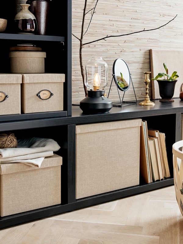 An assortment of storage products from the NEREBY series are mounted on the wall close to a dining table.
