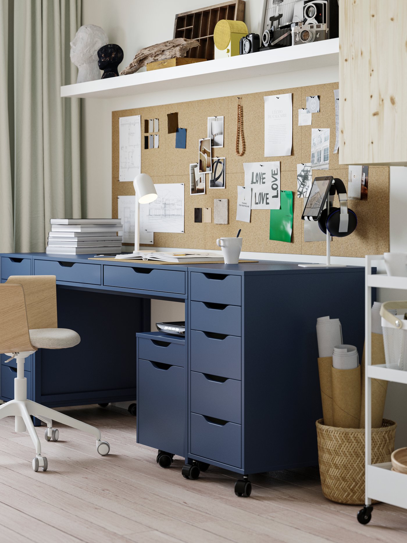 A black-blue ALEX desk in a student room, with on each side a drawer unit. Under the desk sits a smaller drawer unit as too.