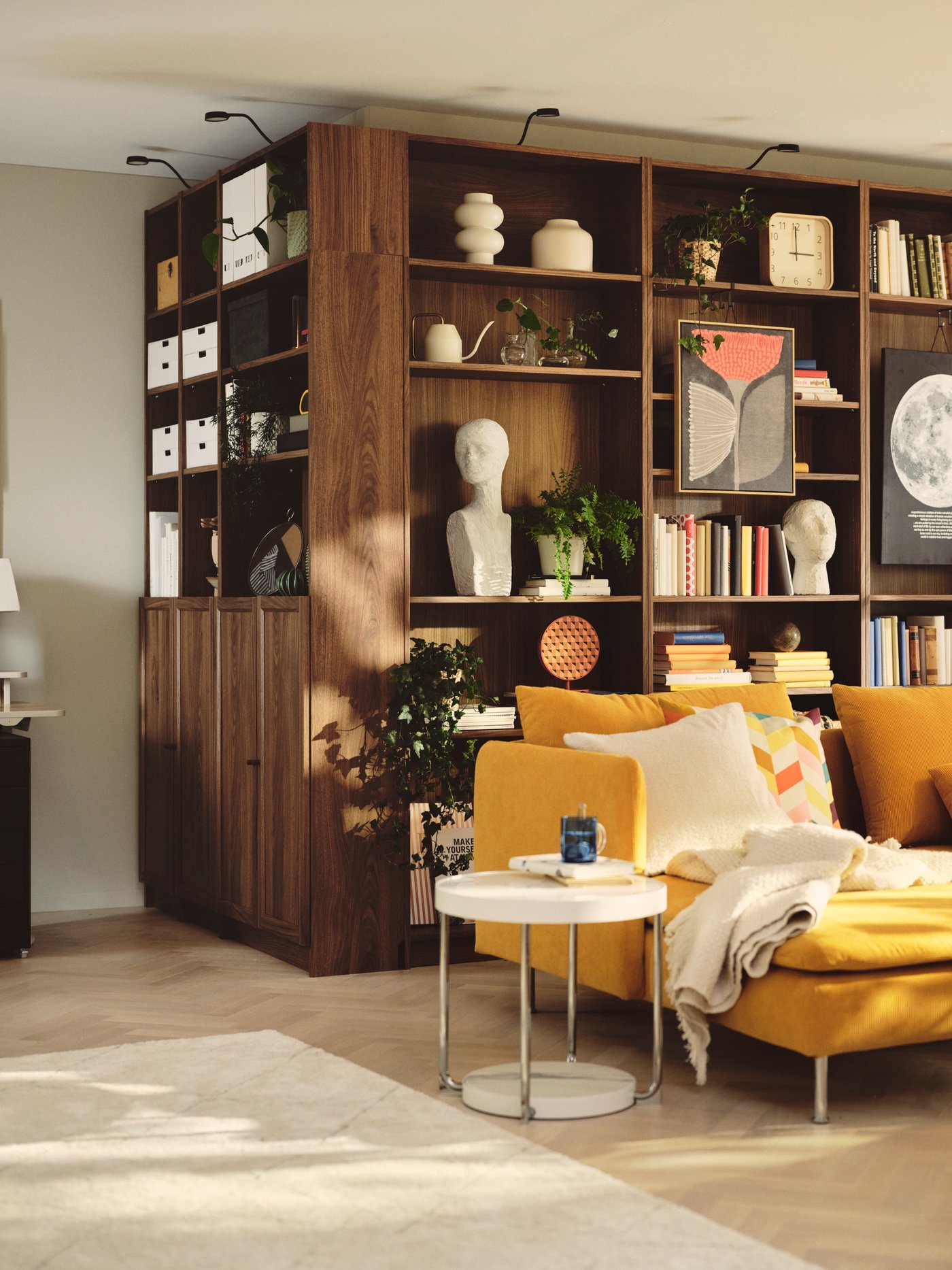 A living room contains a brown BILLY bookcase made from brown walnut effect, filled with books and decorative items.