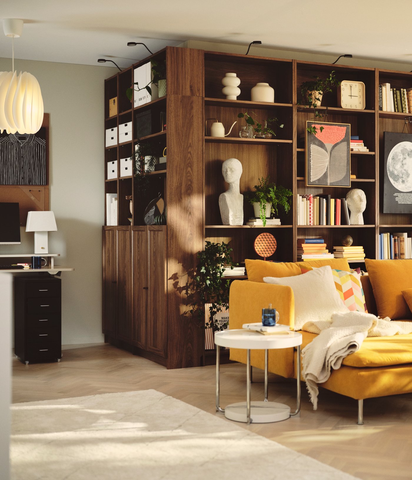 A living room contains a brown BILLY bookcase made from brown walnut effect, filled with books and decorative items.