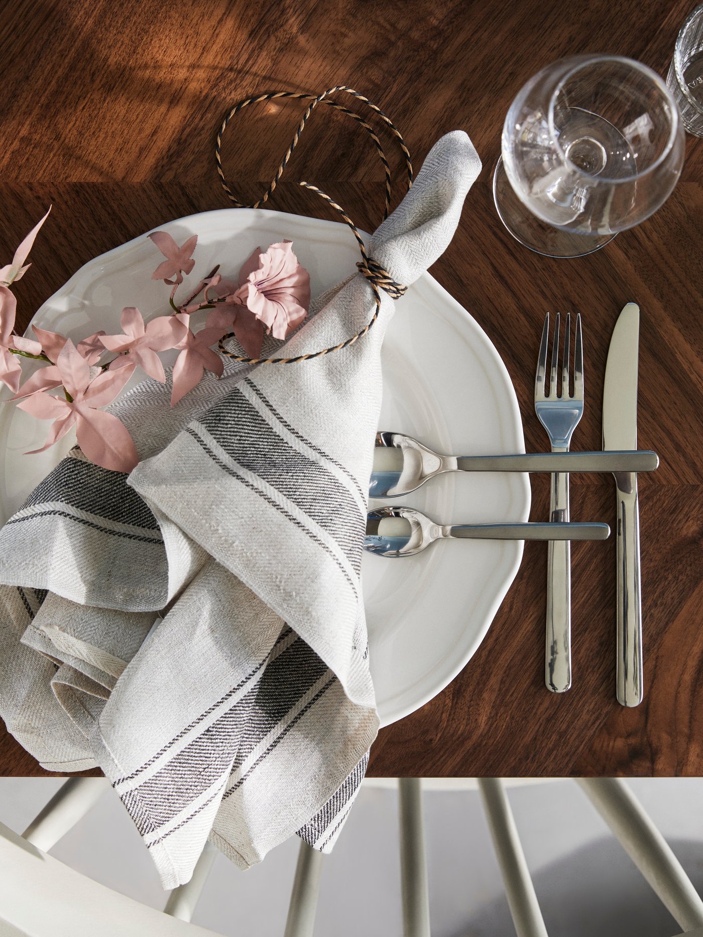 A stainless steel IKEA 365+ 24-piece cutlery set in the dining room