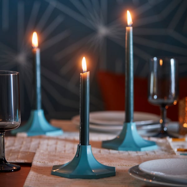 A blue GOKVÄLLÅ candlestick/candle holder