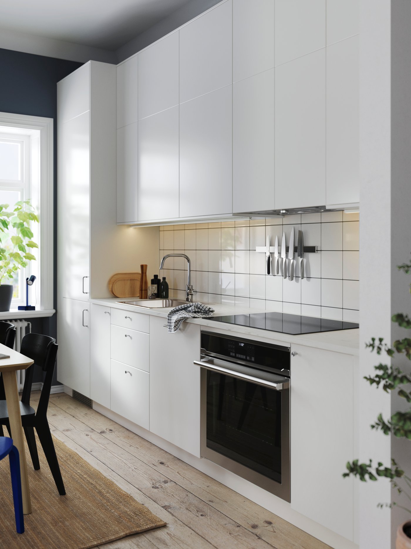 A kitchen with white furniture in a new flat.