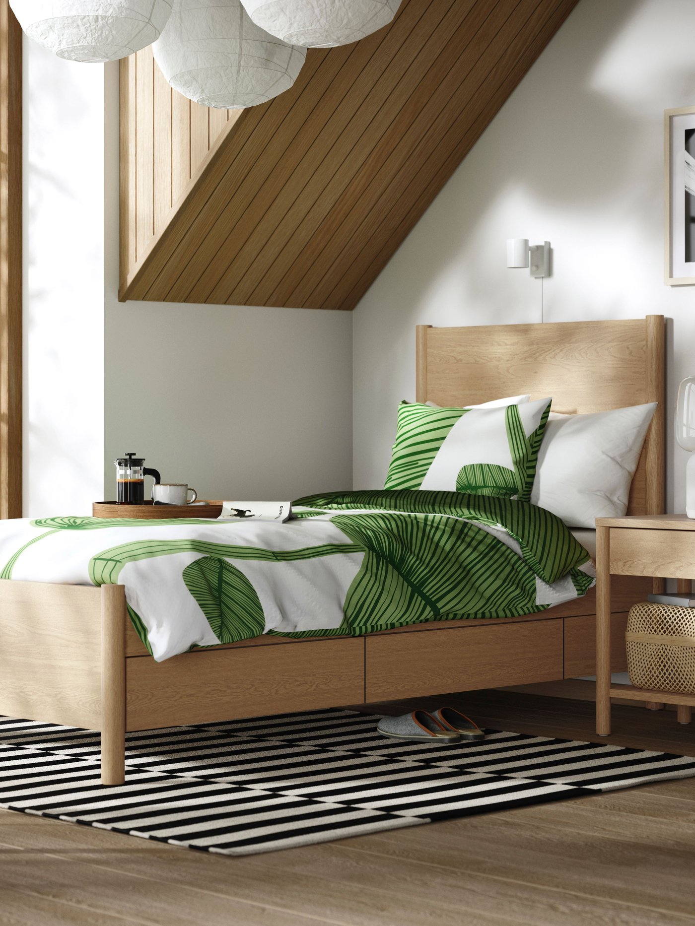 An oak veneer TONSTAD bed frame with storage