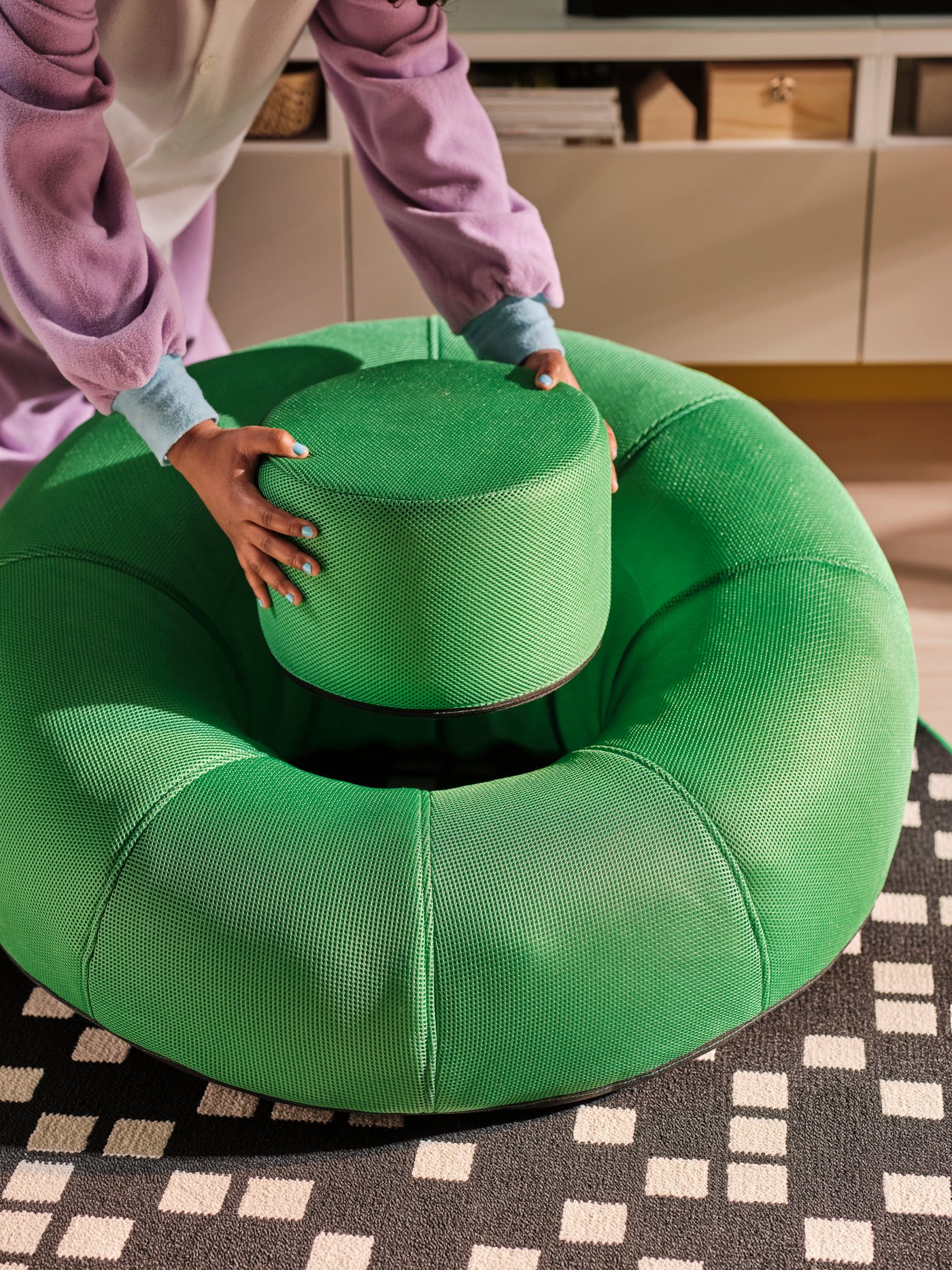 A bright green BRÄNNBOLL inflatable gaming lounge chair