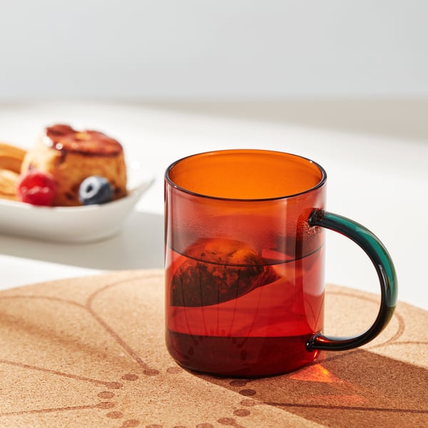 A mixed colours brown/green SKUGGSTUBB mug