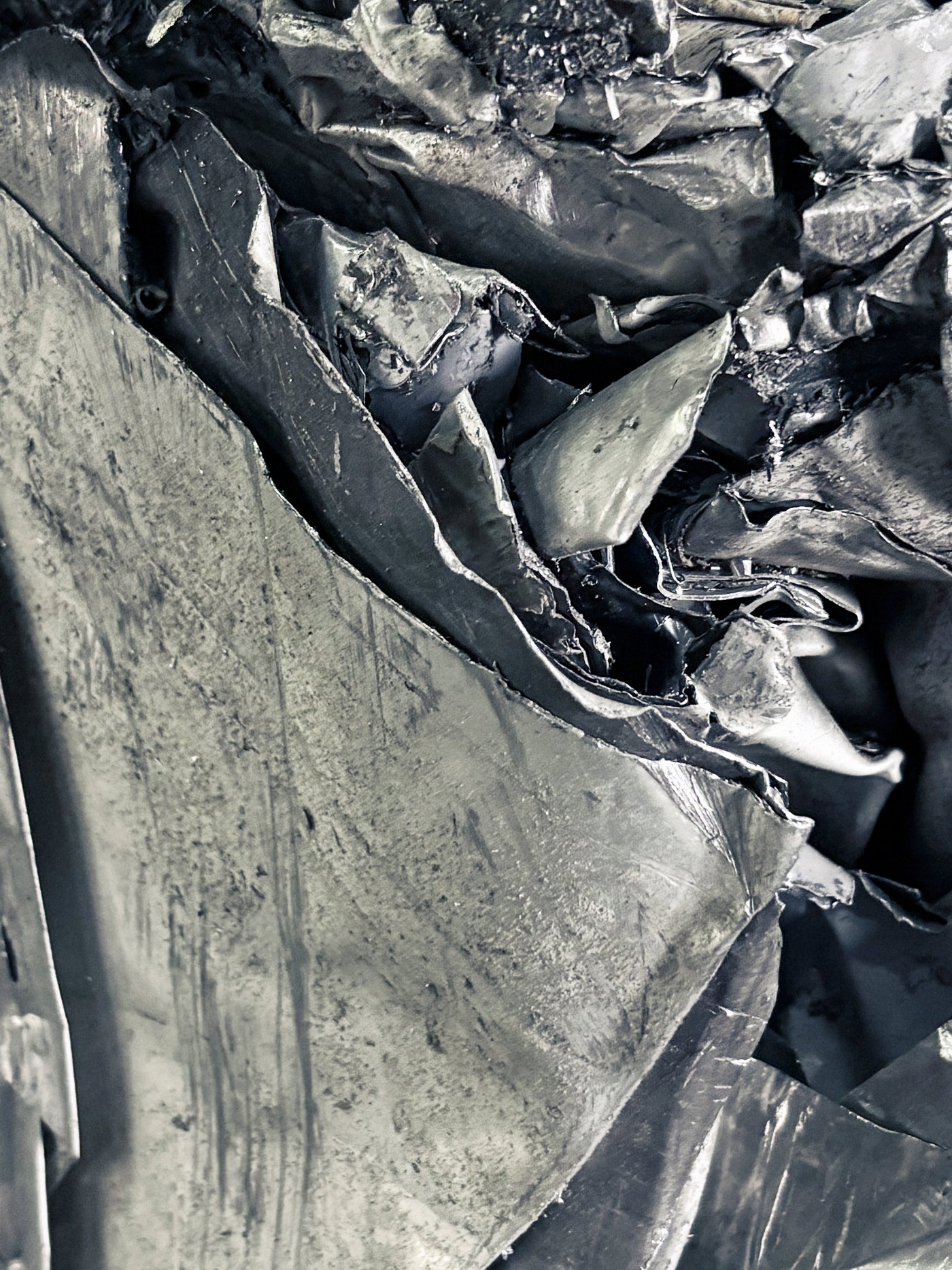 A close-up image of crumpled metallic sheets.