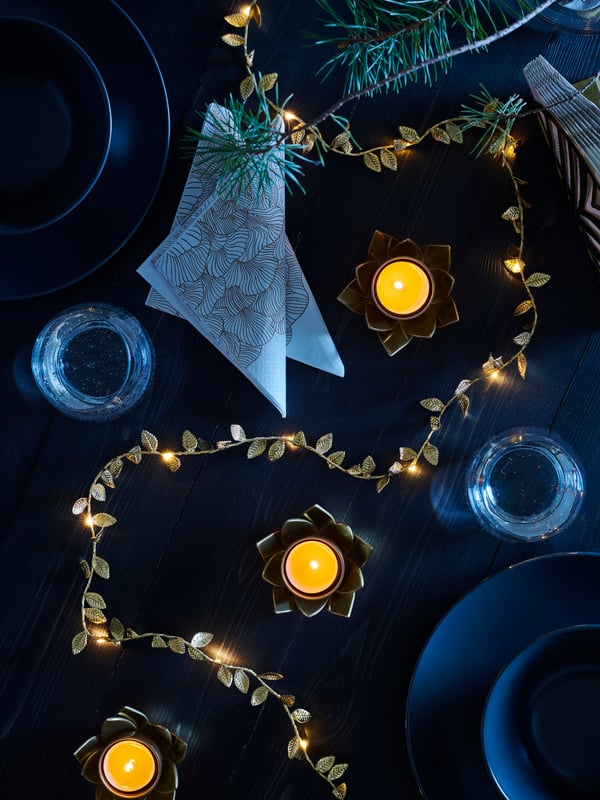 A birds eye biew of a table set with napkins, candles and decorations.