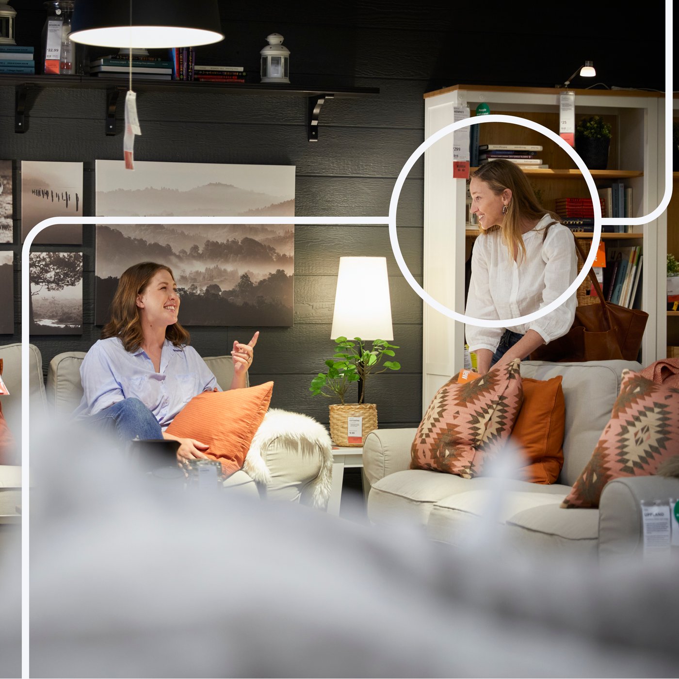 To people are talking together in a lobby area.