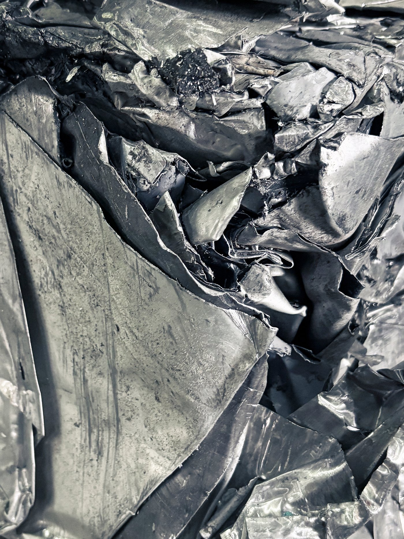 A close-up image of crumpled metallic sheets.
