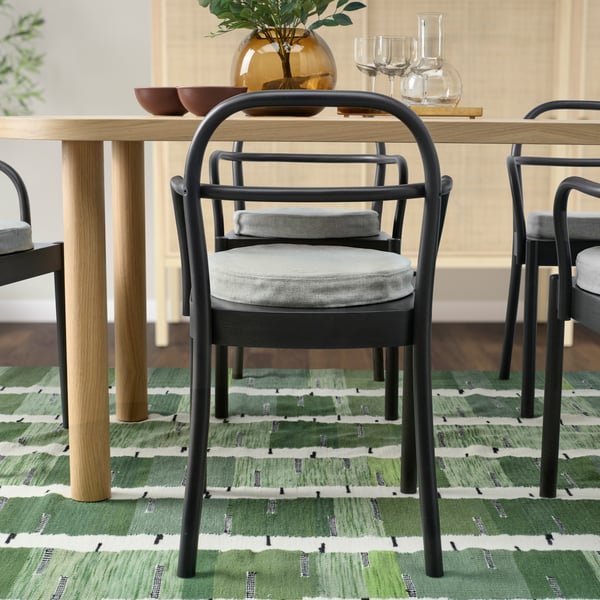 A beige ÅKERVINDEFLY chair pad